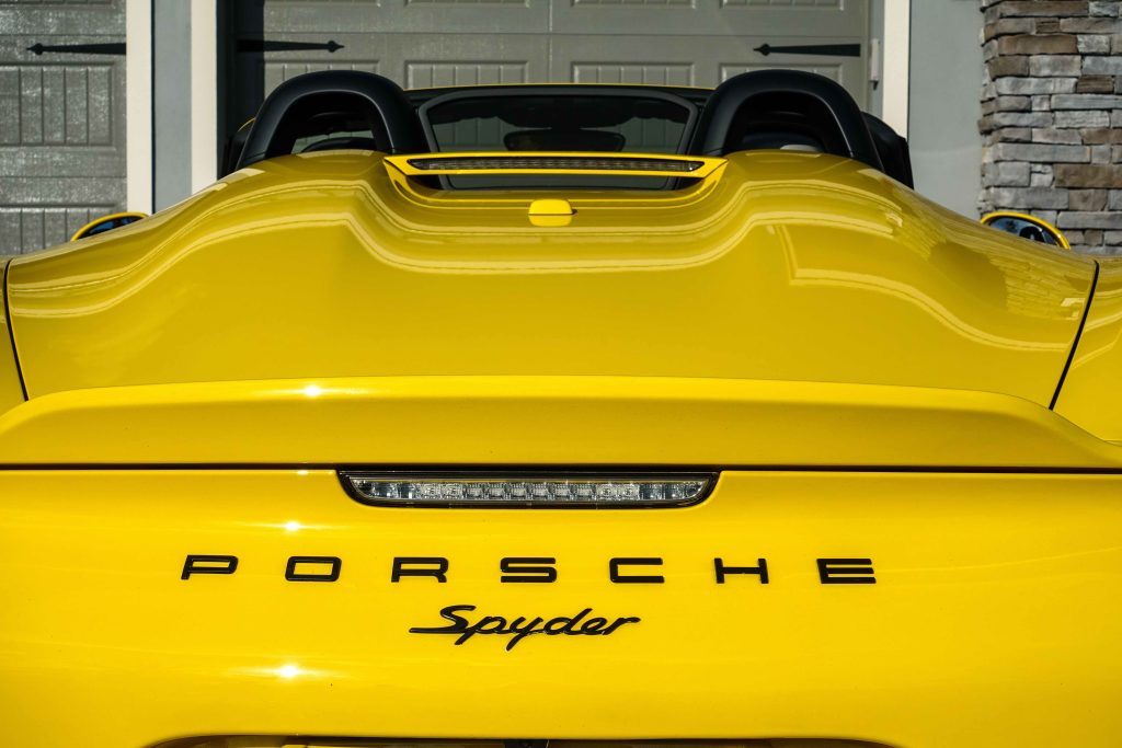 Orlando, FL/USA-1/15/20: The rear end of a yellow Porsche Spyder sitting in front of a home.